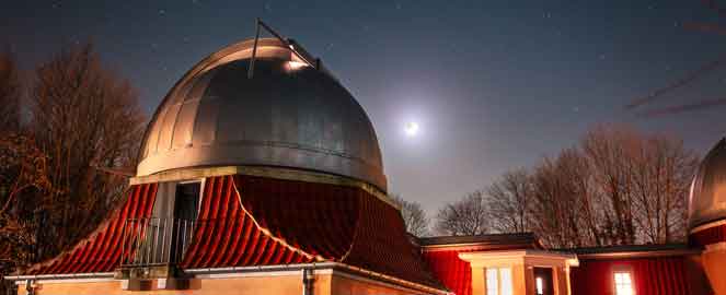The dome of the Ole Rømer Observatory in Aarhus on a moonlit evening